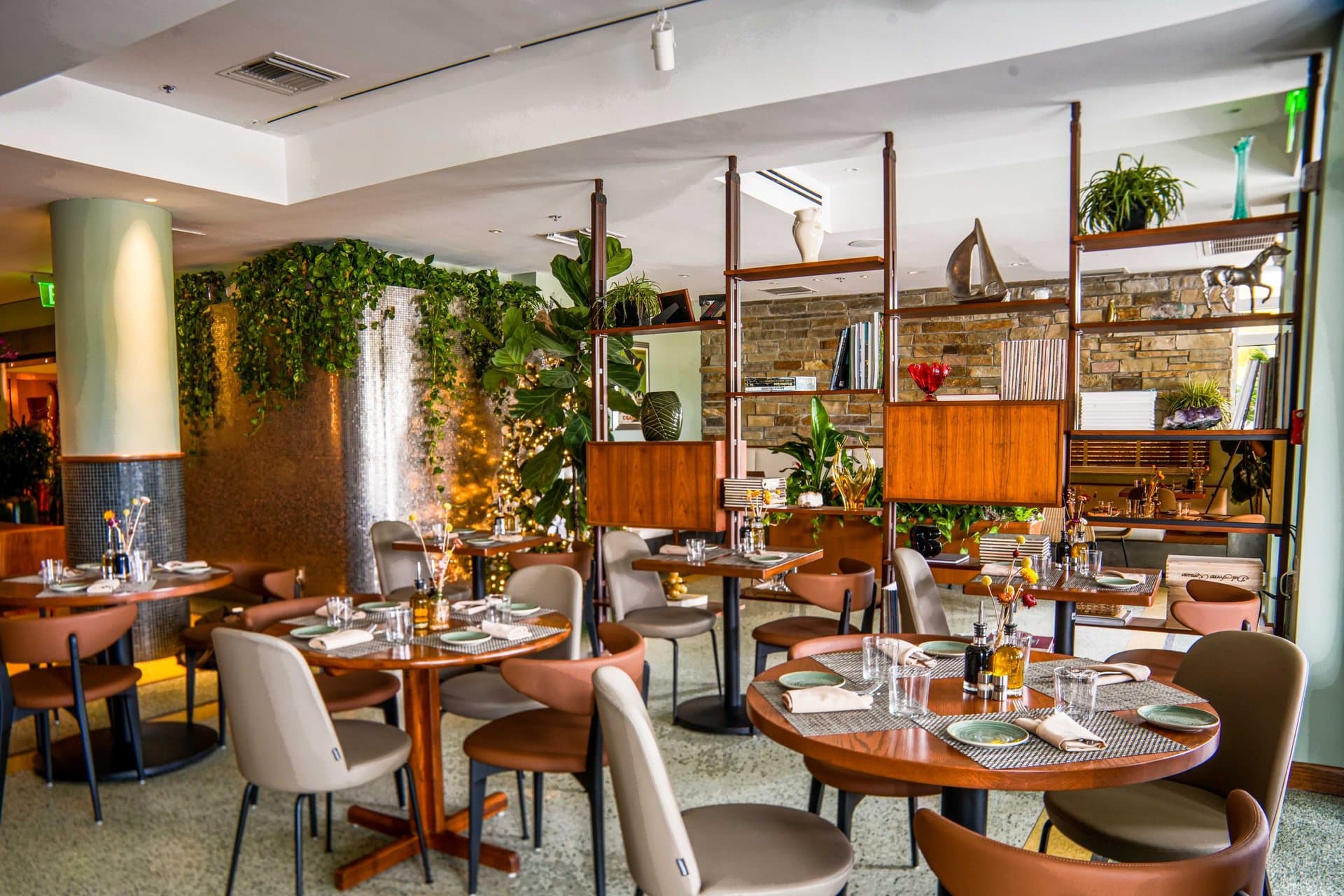 Dining room with banquettes and wooden blinds at Pelican Restaurant on Ocean Drive